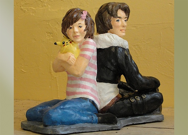 Sculpture of a seated boy and girl